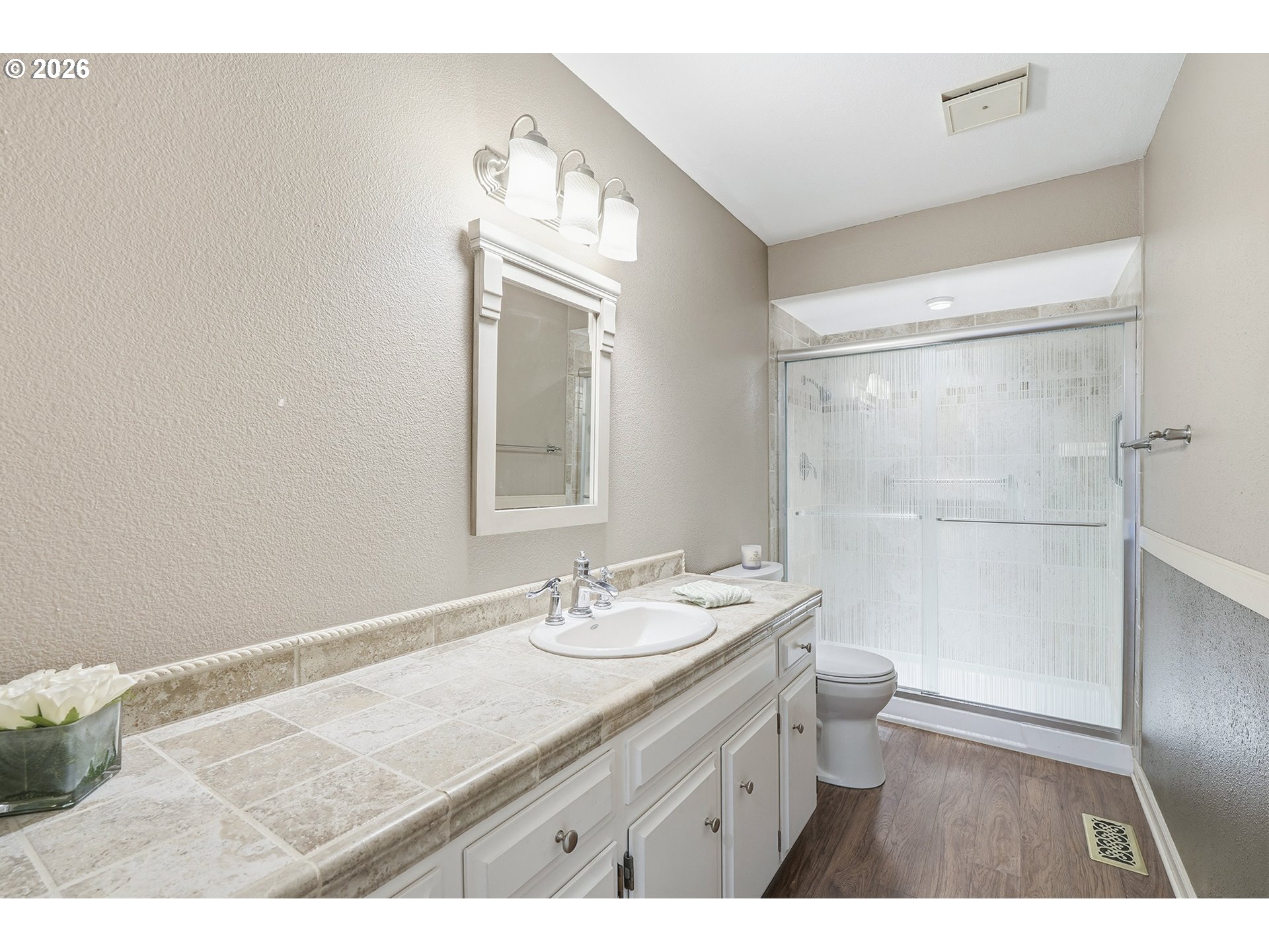 32565 Southwest Lake Point Court Wilsonville, OR 97070 - Photo 40 of 48 a bathroom with a granite countertop sink a toilet a mirror and shower