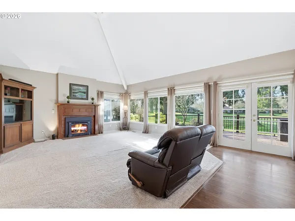 a view of an empty room with a fireplace and a window