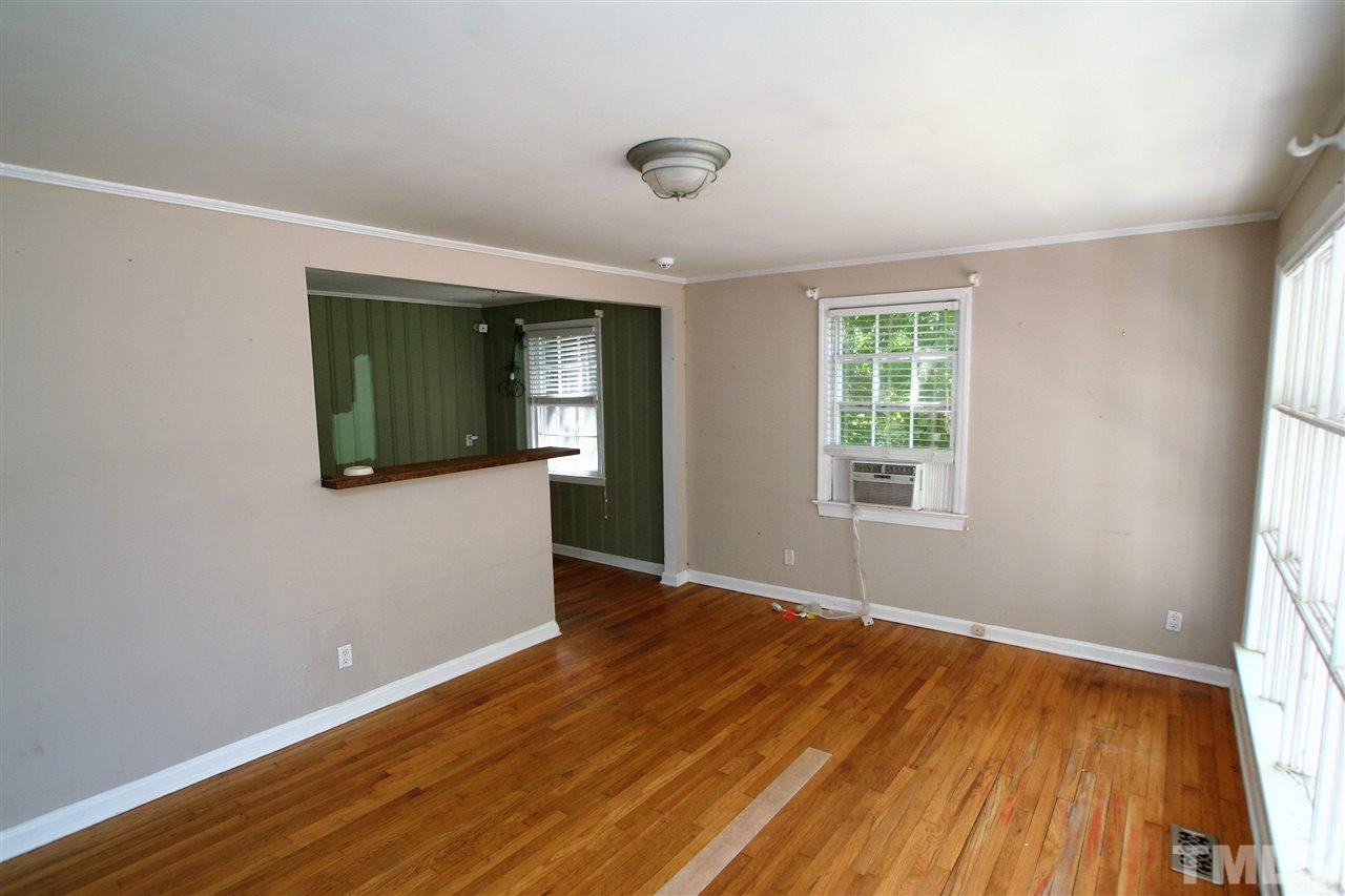 705 Mial Street Raleigh, NC 27608 - Photo 2 of 14 an empty room with wooden floor and windows