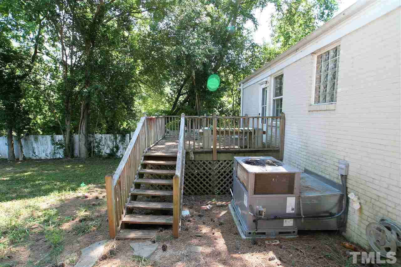 705 Mial Street Raleigh, NC 27608 - Photo 13 of 14 a view of backyard with outdoor seating and trees
