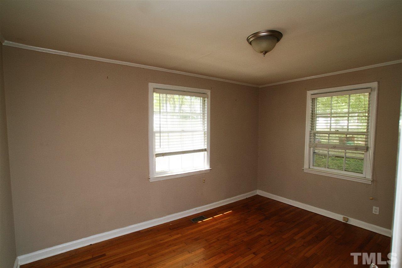 705 Mial Street Raleigh, NC 27608 - Photo 5 of 14 a view of an empty room with wooden floor and a window