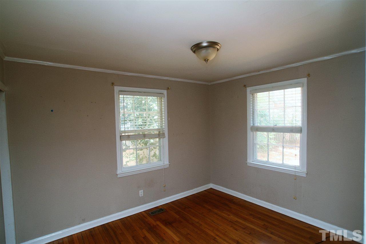 705 Mial Street Raleigh, NC 27608 - Photo 6 of 14 a view of an empty room with wooden floor and a window