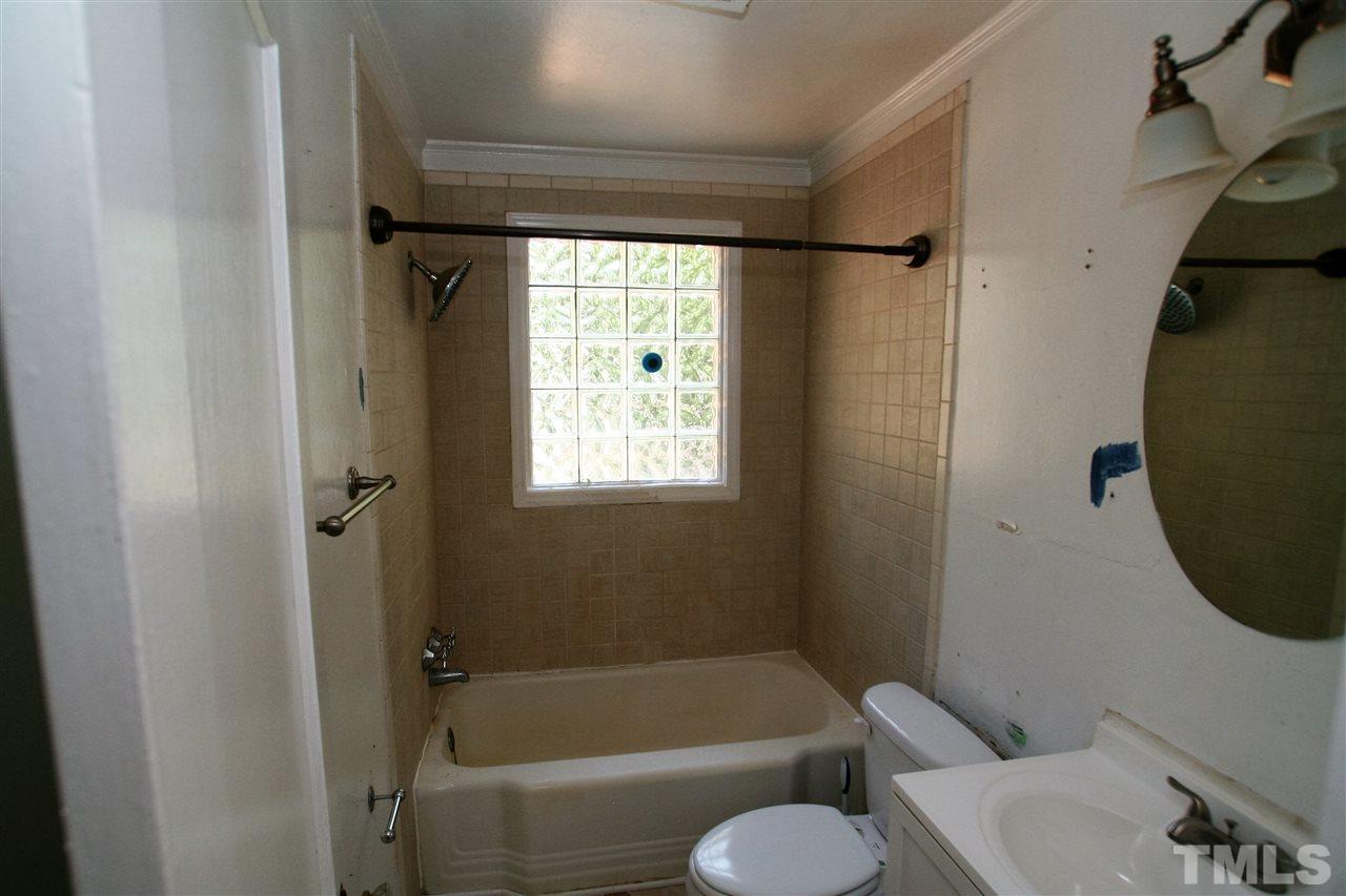 705 Mial Street Raleigh, NC 27608 - Photo 7 of 14 a bathroom with a toilet and a bathtub