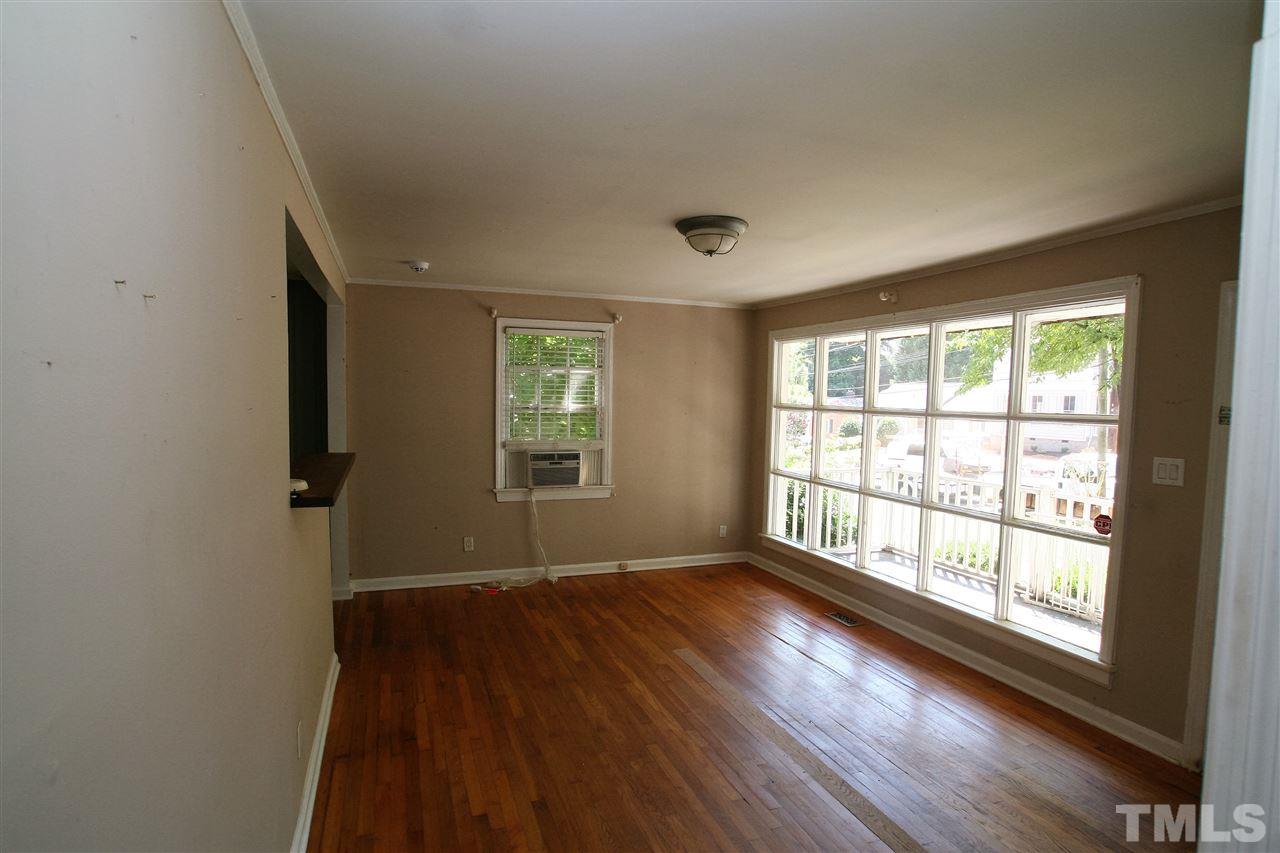 705 Mial Street Raleigh, NC 27608 - Photo 8 of 14 an empty room with wooden floor and windows