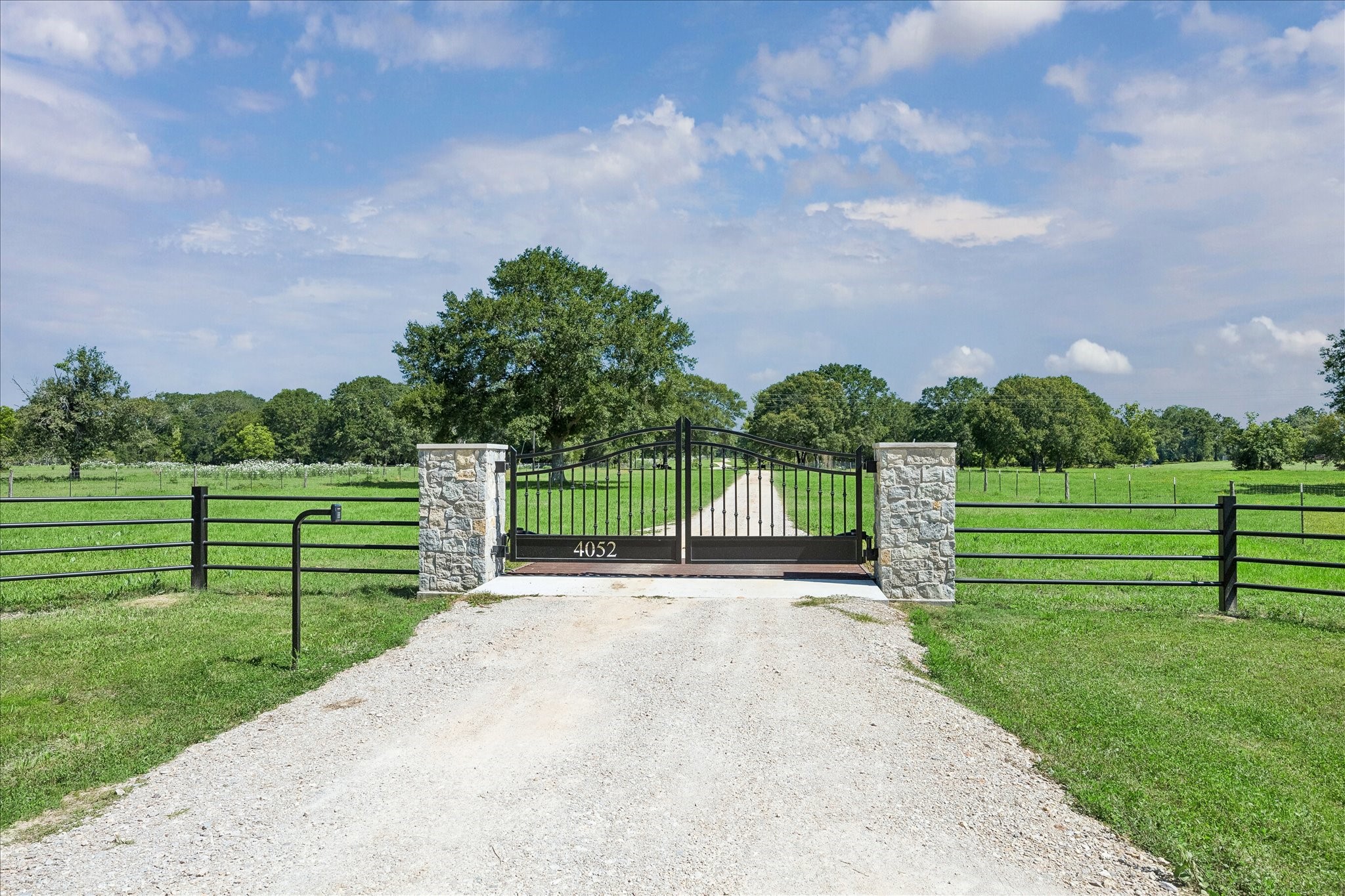 4052 Kuykendall Road Bellville, TX 77418 - Photo 2 of 40 Beautiful, newly installed gate and flanked by stone pillars. Perfect for buyers seeking privacy and open space.