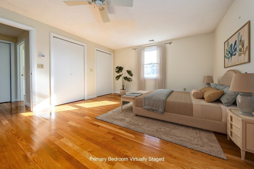 2 Uncle Percy's Road Mashpee, MA 02649 - Photo 19 of 32 a bedroom with a large bed and a chandelier