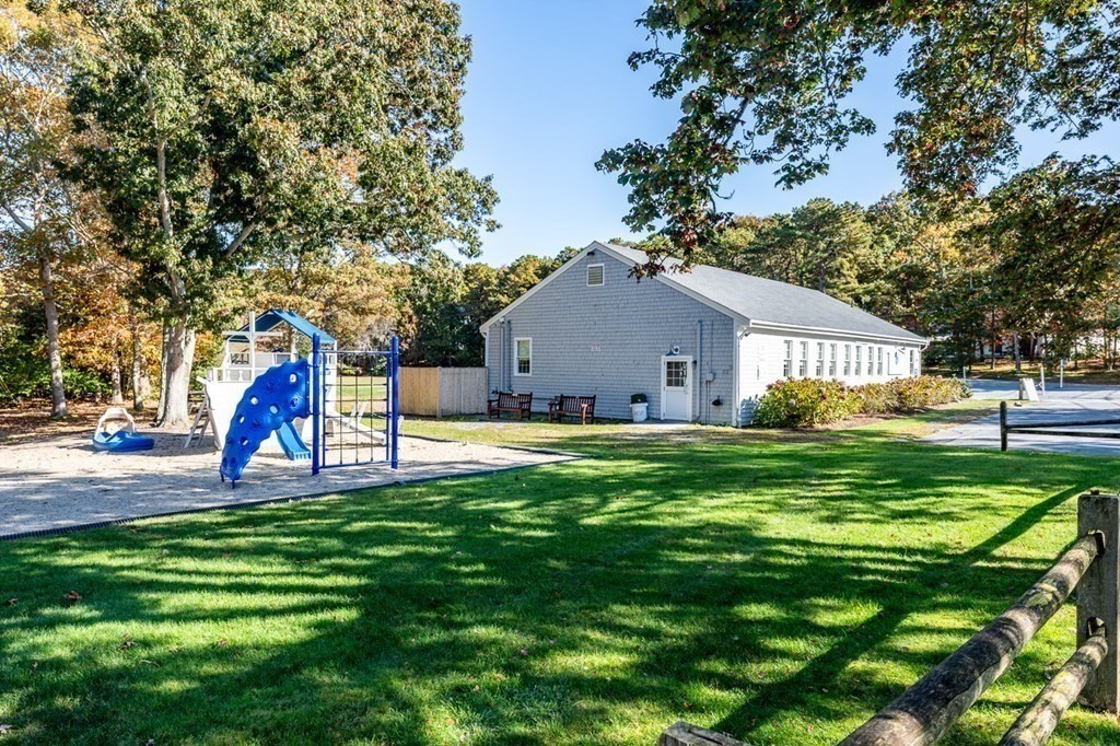 2 Uncle Percy's Road Mashpee, MA 02649 - Photo 28 of 32 a view of a house with a backyard and a tree