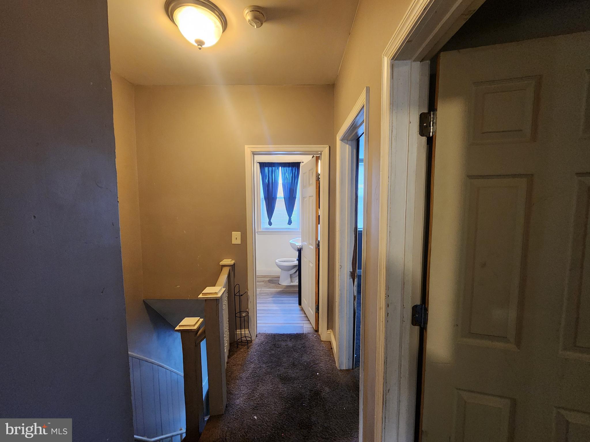 3213 Spaulding Avenue Baltimore, MD 21215 - Photo 20 of 26 a view of a hallway with wooden shelves