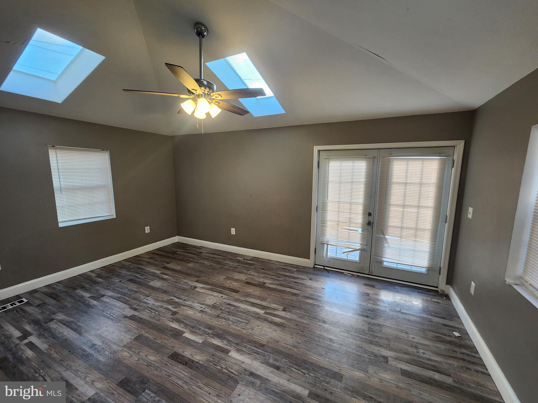 3213 Spaulding Avenue Baltimore, MD 21215 - Photo 5 of 26 a view of an empty room with wooden floor and a window