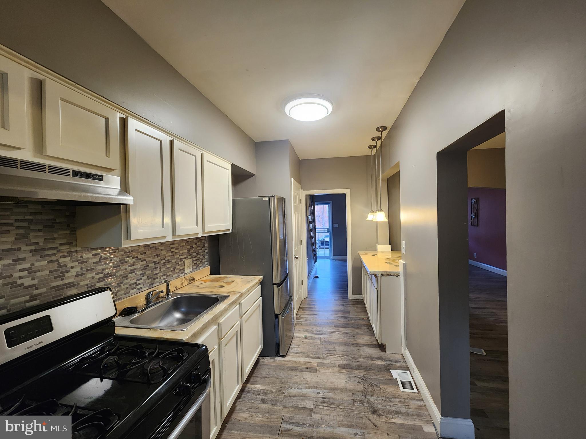 3213 Spaulding Avenue Baltimore, MD 21215 - Photo 6 of 26 a kitchen with stainless steel appliances granite countertop a stove and a refrigerator