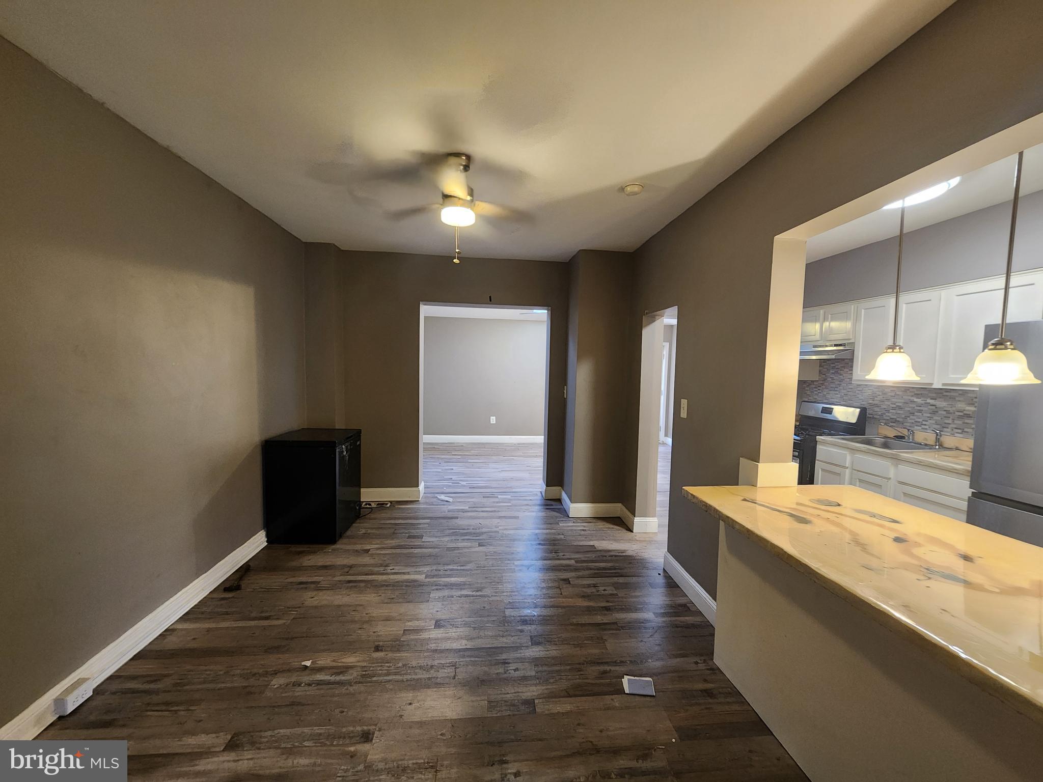 3213 Spaulding Avenue Baltimore, MD 21215 - Photo 9 of 26 a large room with lots of counter space and wooden floor