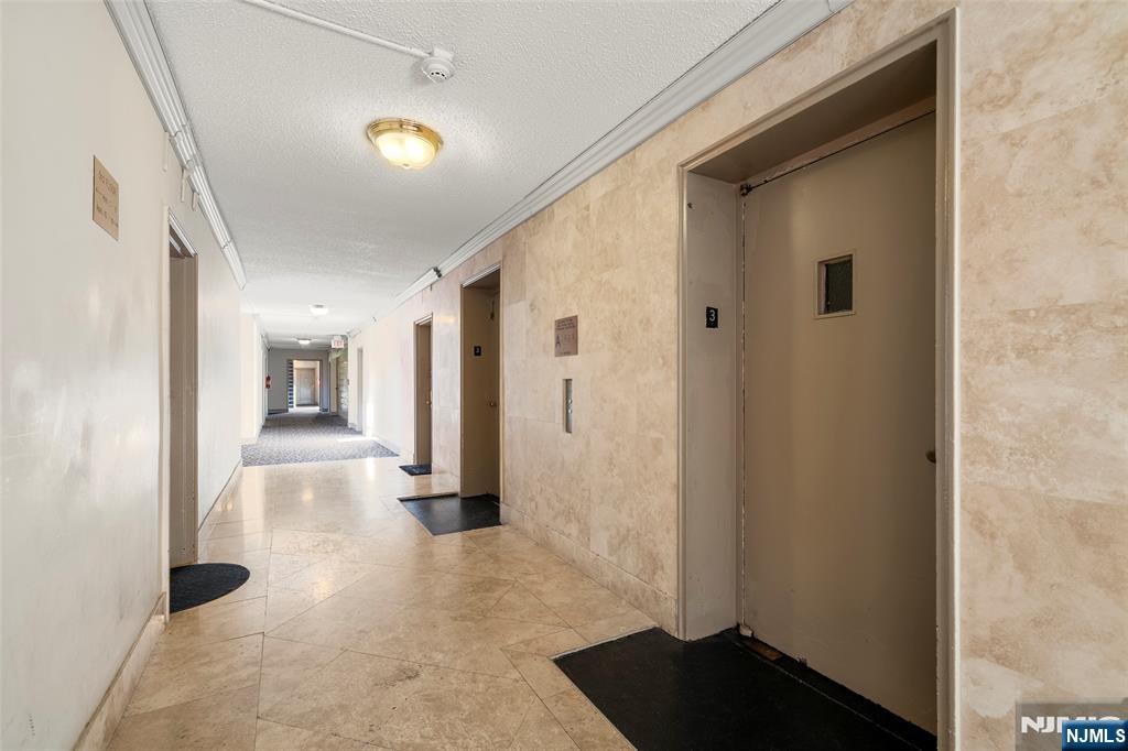 2337 Hudson Terrace, Unit C11 Fort Lee, NJ 07024 - Photo 16 of 23 a view of a hallway with wooden floor and staircase