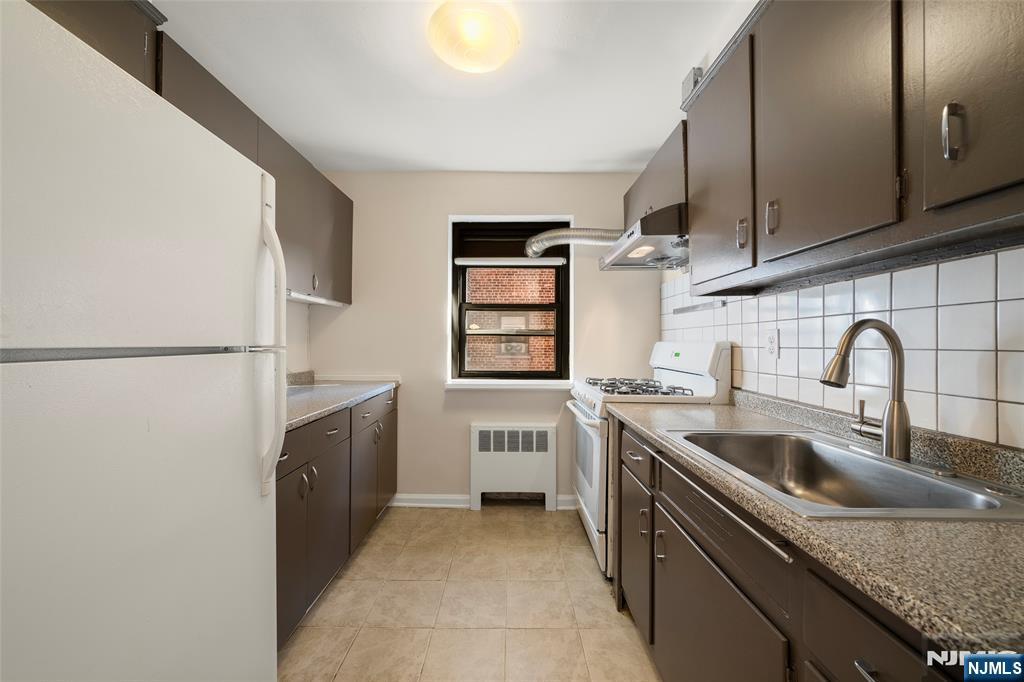 2337 Hudson Terrace, Unit C11 Fort Lee, NJ 07024 - Photo 9 of 23 a kitchen with stainless steel appliances granite countertop a sink stove and refrigerator