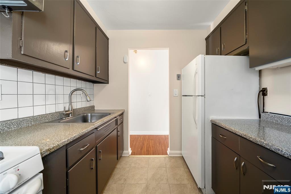 2337 Hudson Terrace, Unit C11 Fort Lee, NJ 07024 - Photo 10 of 23 a kitchen with stainless steel appliances granite countertop a sink stove and refrigerator