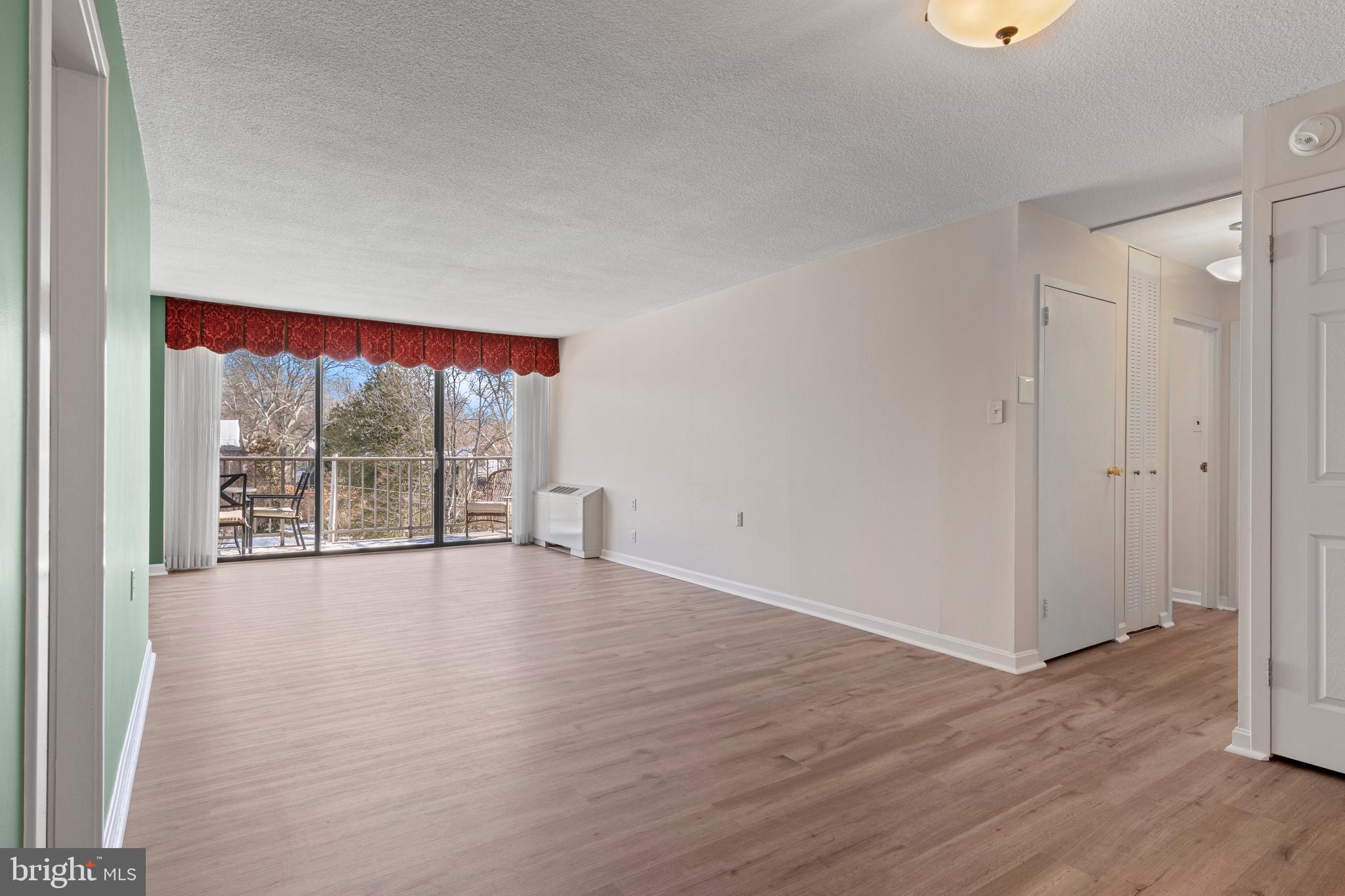 801 Yale Avenue, Unit 919 Swarthmore, PA 19081 - Photo 12 of 26 a view of an empty room with wooden floor and a window