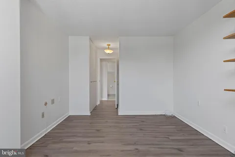 a view of an empty room and wooden floor