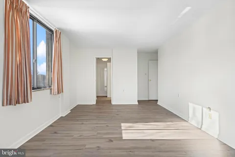 a view of an entryway with wooden floor