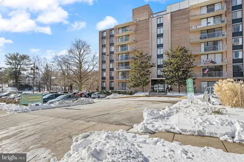 a view of a building with snow on the road