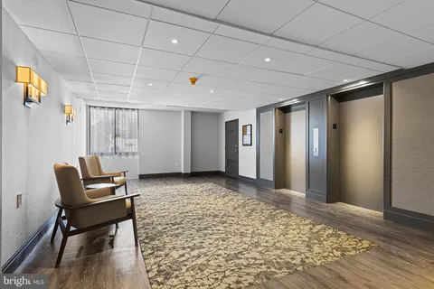 a view of a hallway with wooden floor and a window