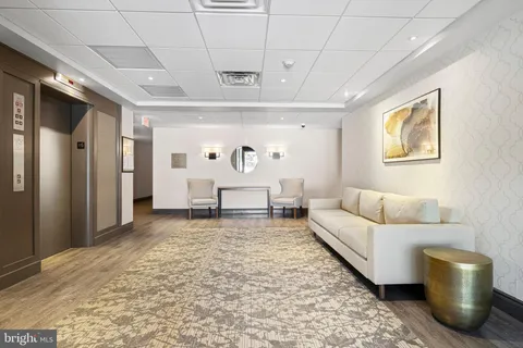 a living room with furniture and a rug