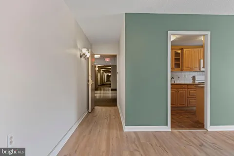 a view of hallway with wooden floor