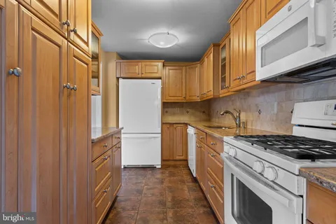 a kitchen with cabinets and a stove top oven