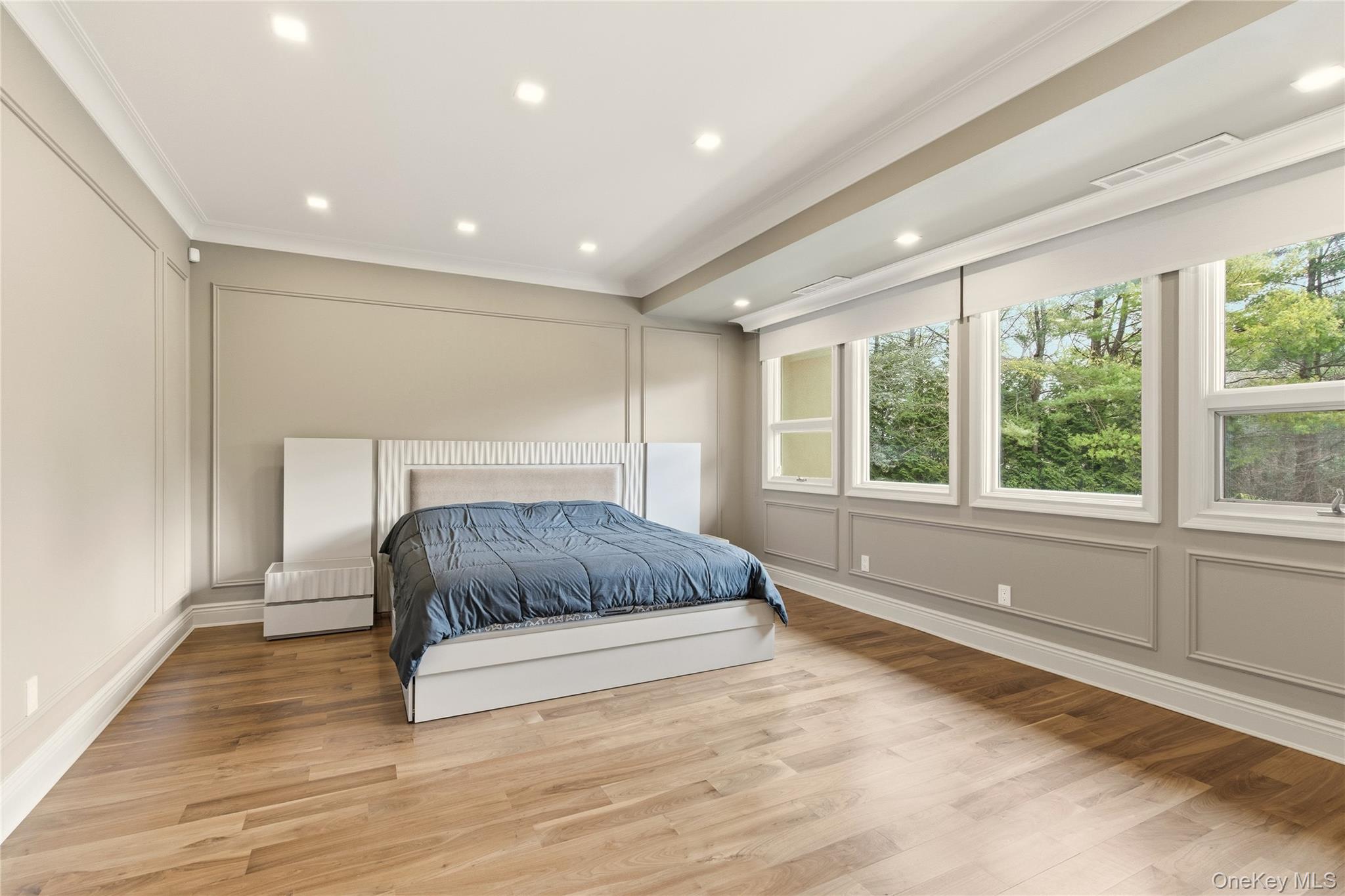 55 Coves Run Syosset, NY 11791 - Photo 30 of 50 a spacious bedroom with a large bed and a large window