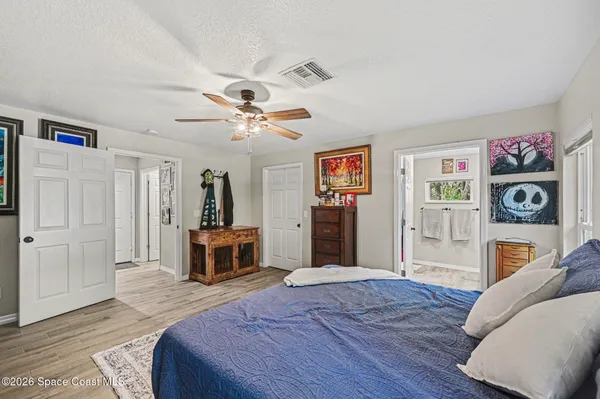 a bedroom with furniture and a mirror
