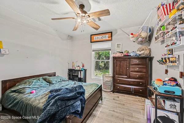 a bedroom with a bed and a bookshelf