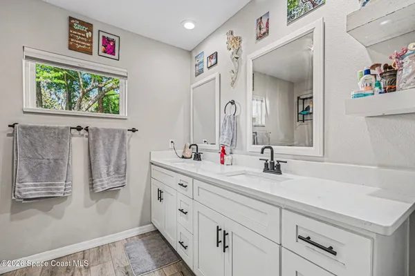a bathroom with a double vanity sink mirror and double