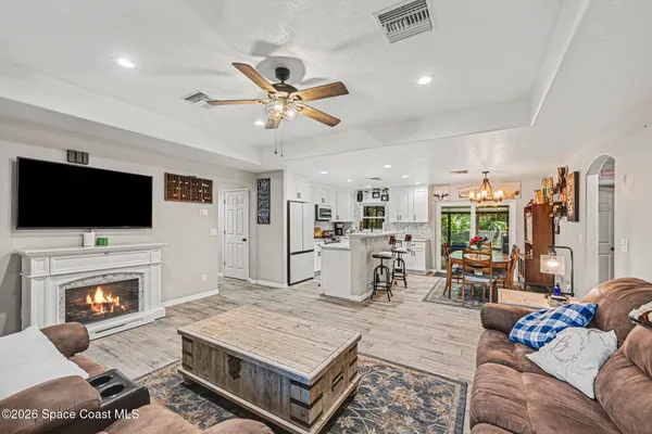 a living room with furniture fireplace and flat screen tv