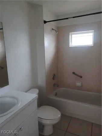 a white toilet sitting next to a bath tub