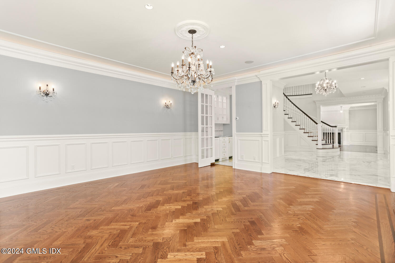 386 Westover Road Stamford, CT 06902 - Photo 11 of 32 a view of an empty room with wooden floor and a chandelier