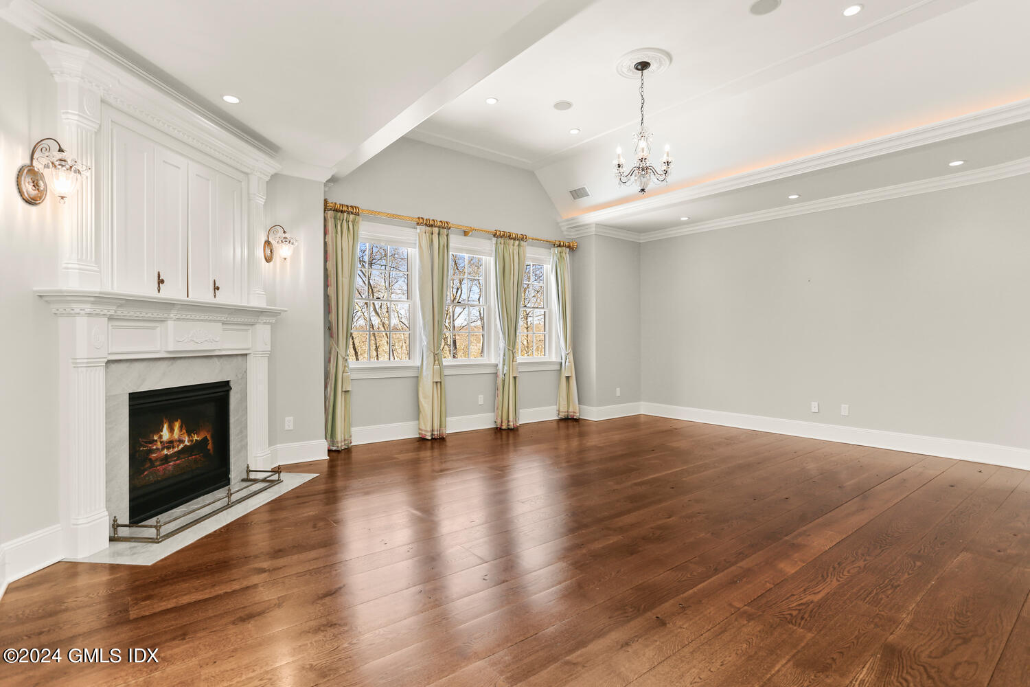 386 Westover Road Stamford, CT 06902 - Photo 17 of 32 a view of an empty room with wooden floor fireplace and a window