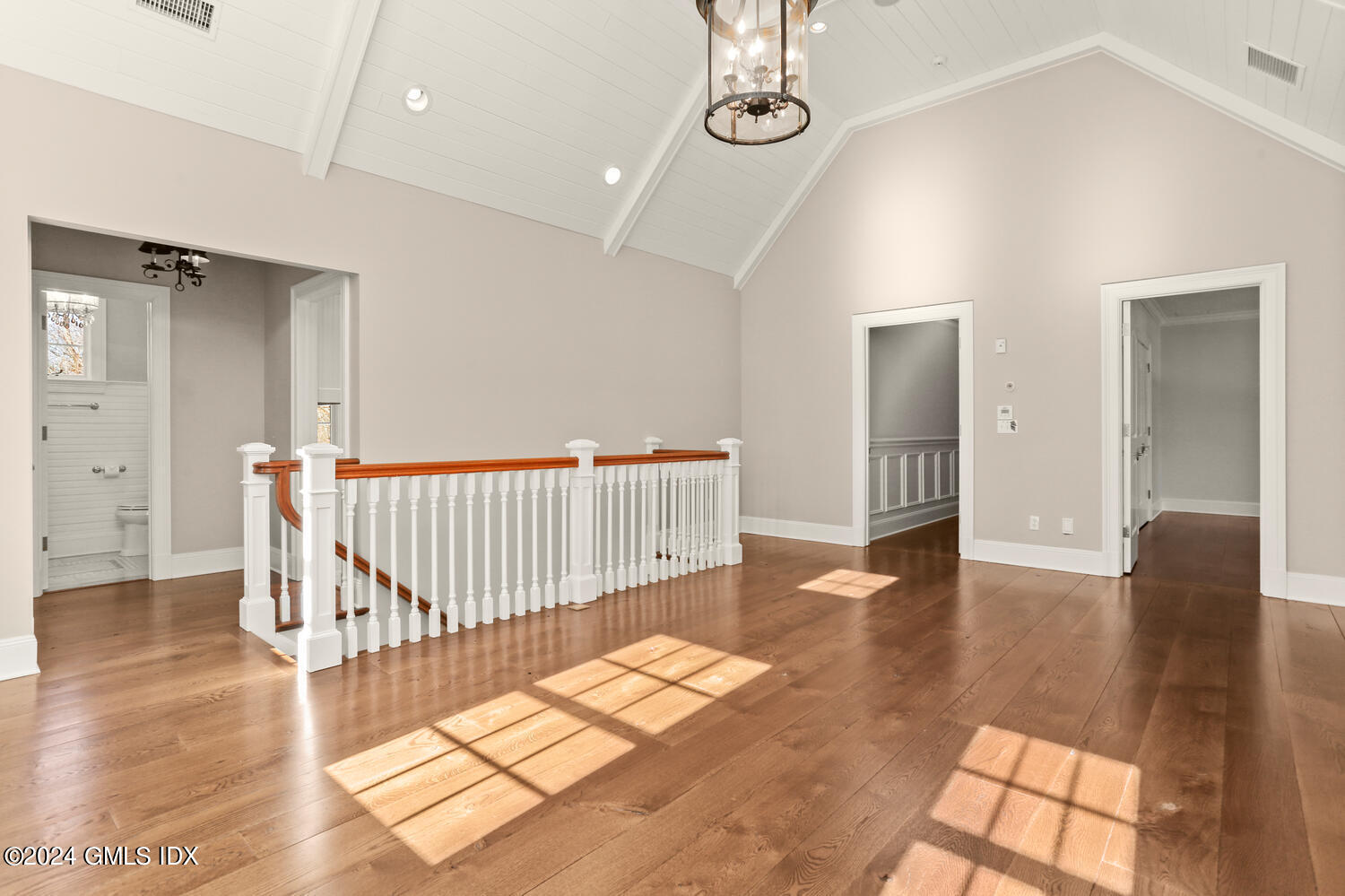 386 Westover Road Stamford, CT 06902 - Photo 22 of 32 a view of a hallway with wooden floor and windows