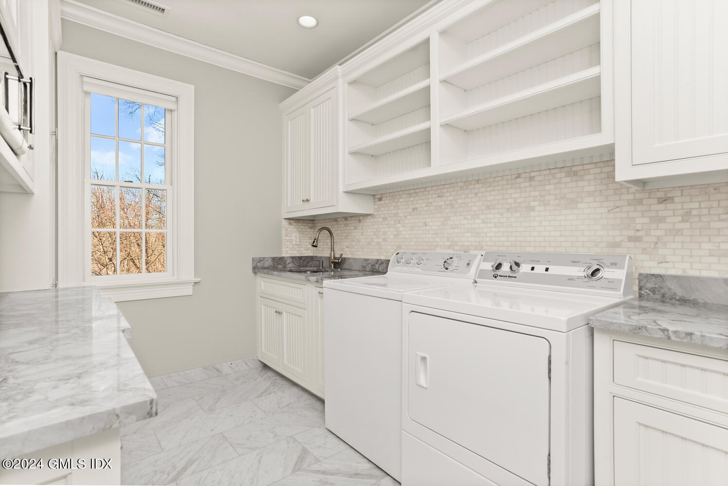 386 Westover Road Stamford, CT 06902 - Photo 23 of 32 a utility room with cabinets washer and dryer