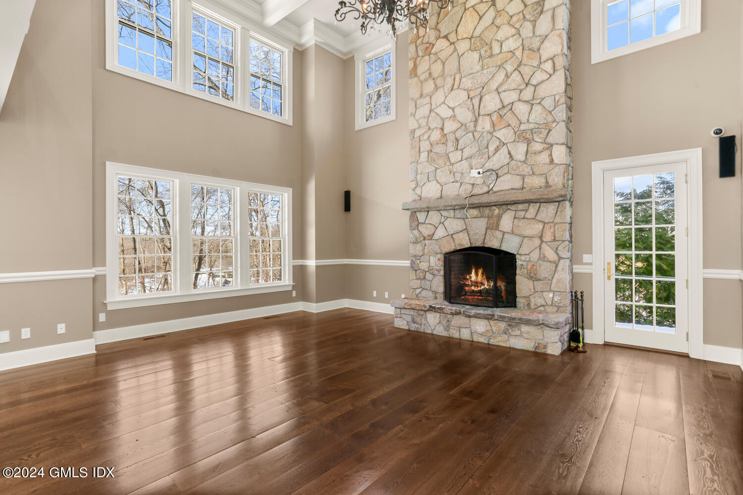 386 Westover Road Stamford, CT 06902 - Photo 6 of 32 a view of an empty room with wooden floor and a window