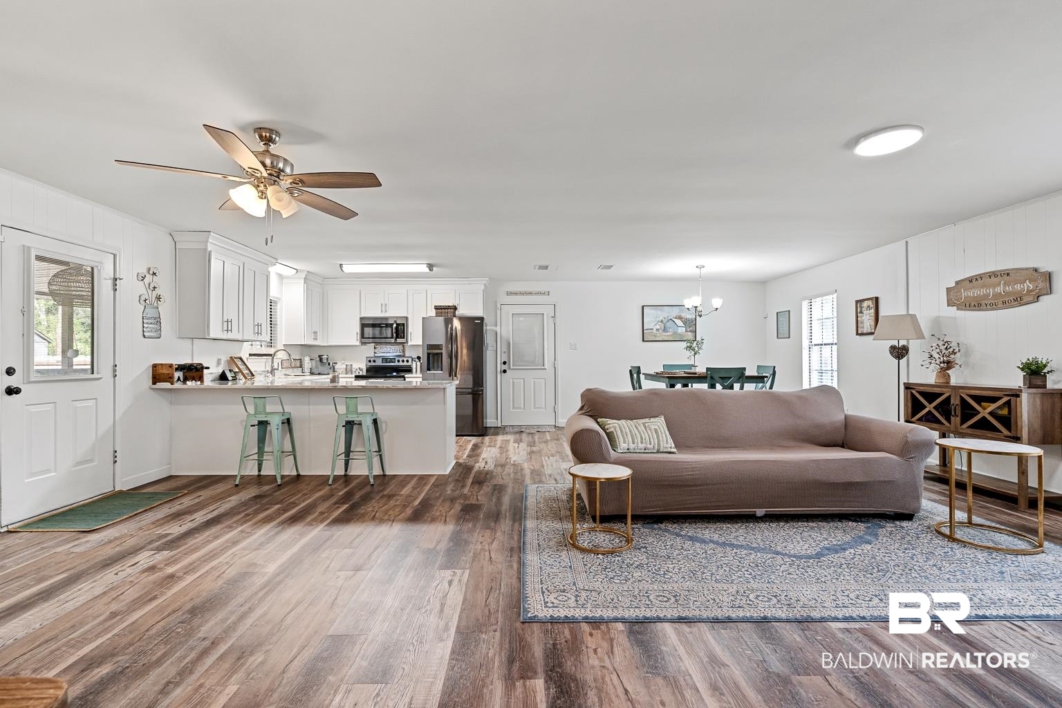 6801 Piney Woods Road Foley, AL 36535 - Photo 32 of 74 Living area featuring dark wood-type flooring, a chandelier, and a ceiling fan