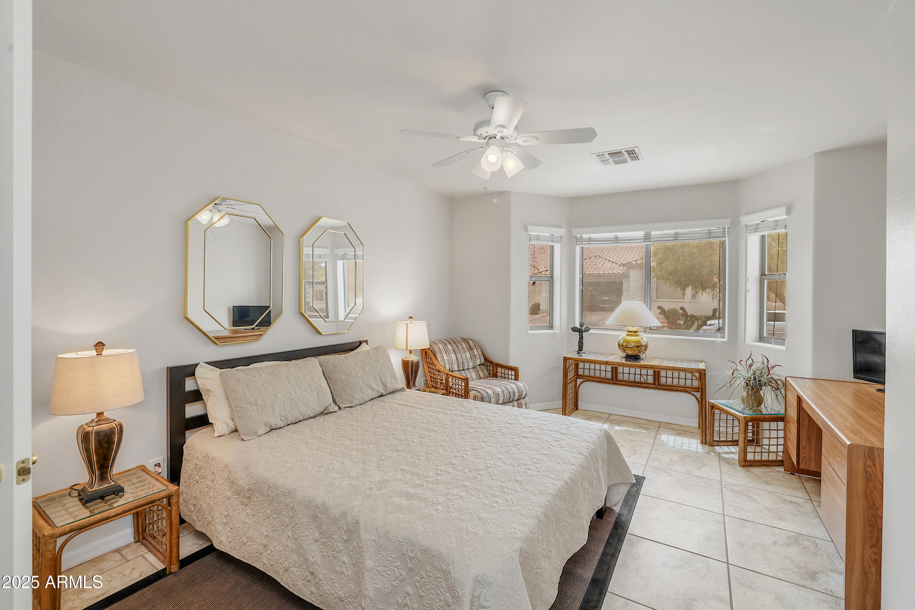 5830 East McKellips Road, Unit 30 Mesa, AZ 85215 - Photo 15 of 34 a bedroom with a large bed and a chandelier