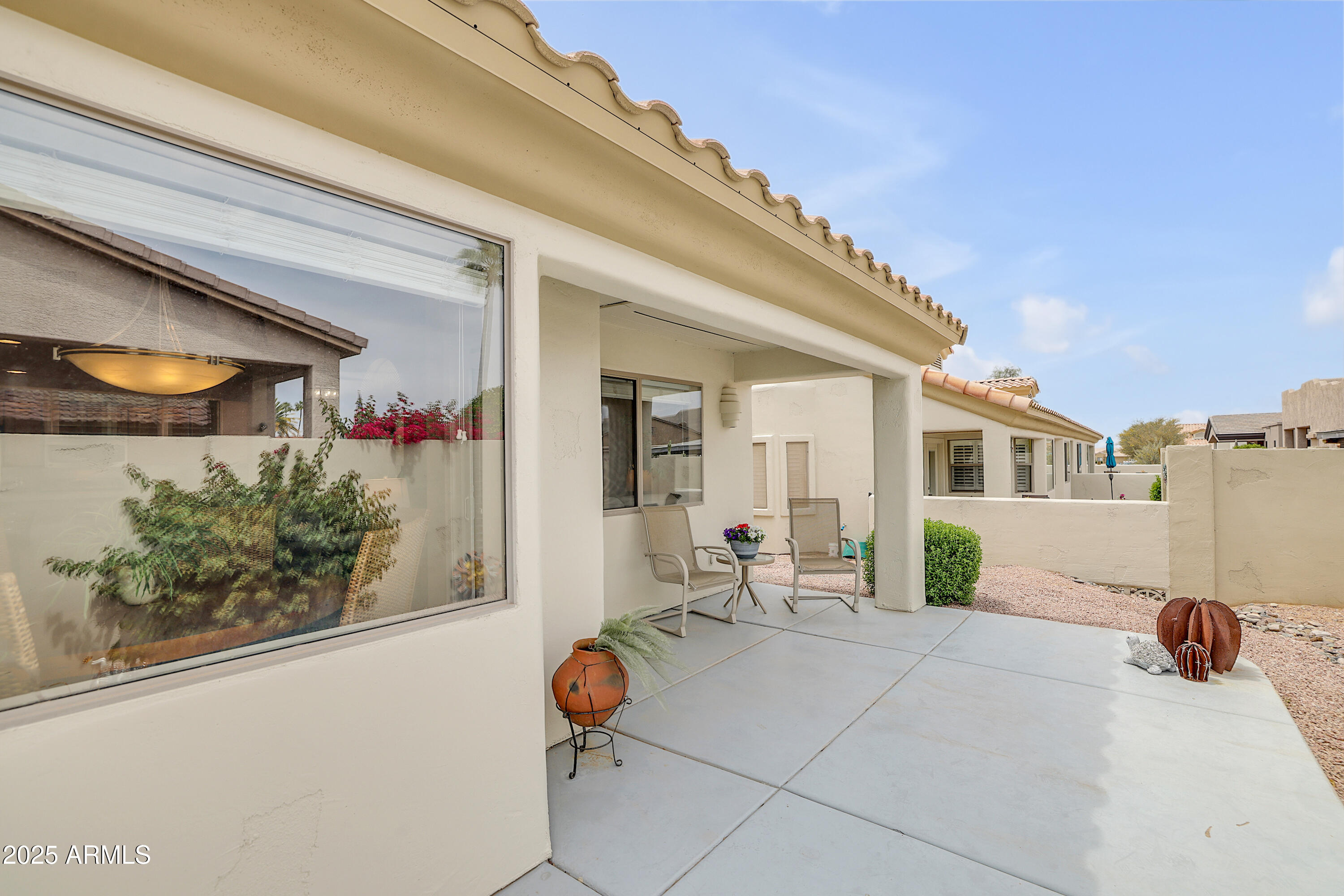 5830 East McKellips Road, Unit 30 Mesa, AZ 85215 - Photo 22 of 34 a view of a house with sitting area and potted plants