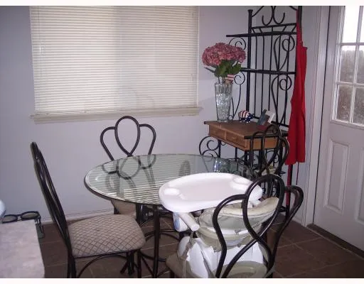 a view of a dining room with furniture and a window