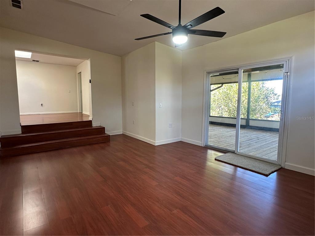 627 Prairie Lane Altamonte Springs, FL 32714 - Photo 13 of 32 an empty room with wooden floor and windows