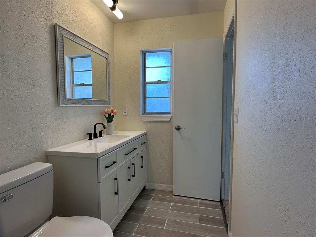 627 Prairie Lane Altamonte Springs, FL 32714 - Photo 19 of 32 a bathroom with a toilet sink and mirror