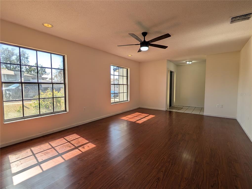 627 Prairie Lane Altamonte Springs, FL 32714 - Photo 3 of 32 a view of empty room with wooden floor and fan