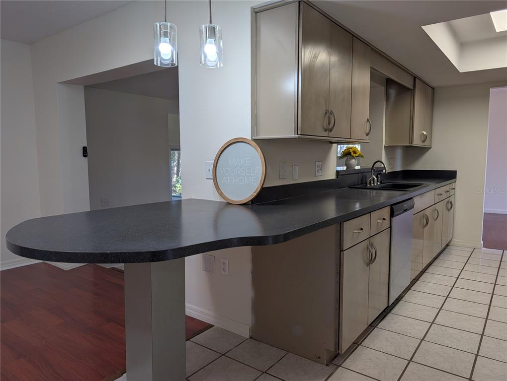 627 Prairie Lane Altamonte Springs, FL 32714 - Photo 10 of 32 a kitchen with granite countertop a sink a cabinets and stainless steel appliances