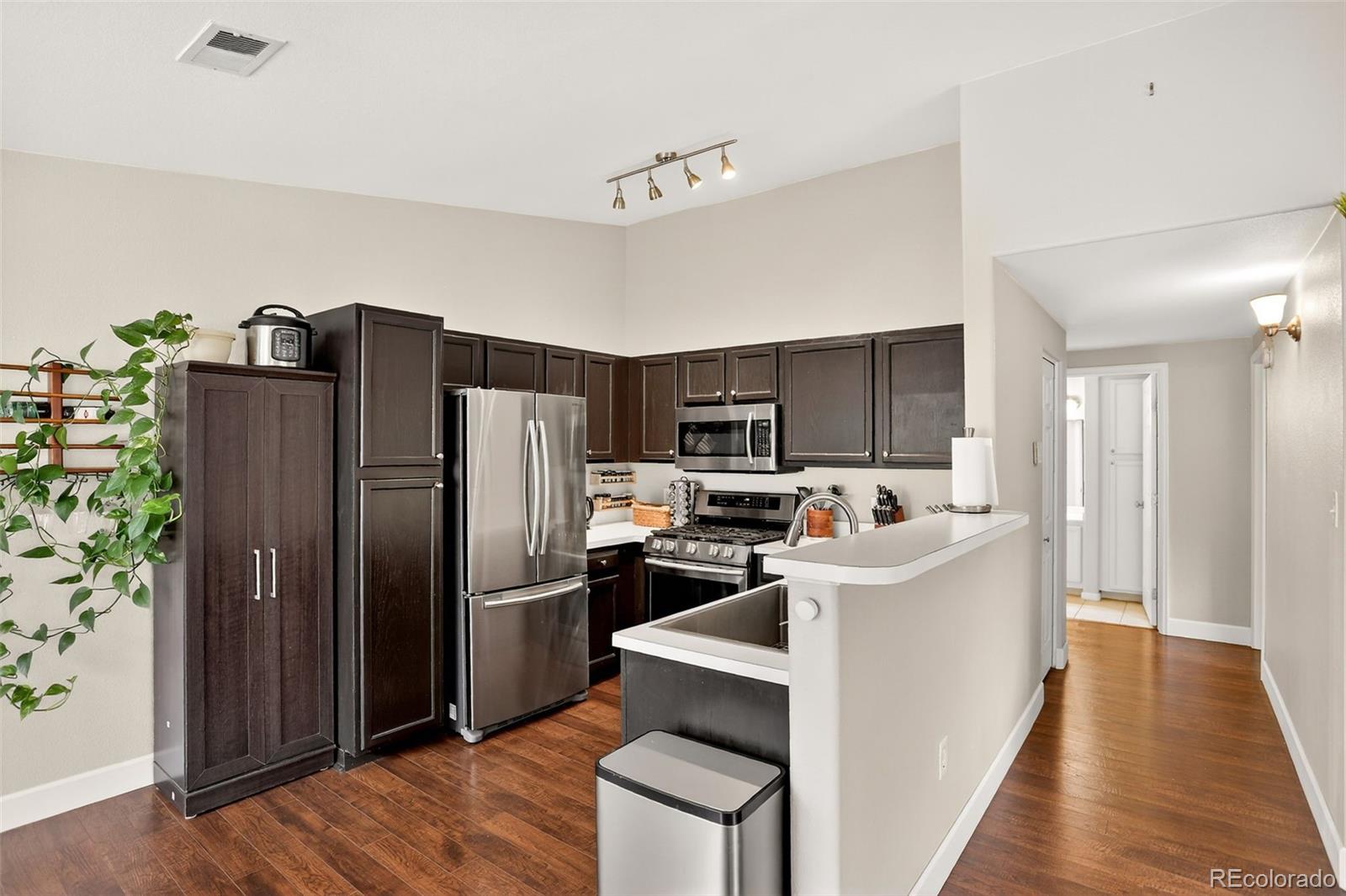 8415 Pebble Creek Way, Unit 203 Highlands Ranch, CO 80126 - Photo 12 of 36 a kitchen with stainless steel appliances a refrigerator and a stove