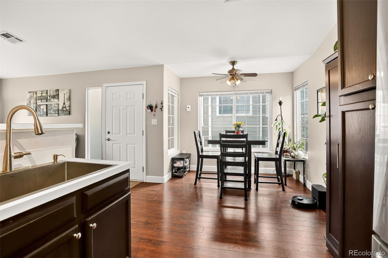8415 Pebble Creek Way, Unit 203 Highlands Ranch, CO 80126 - Photo 13 of 36 a view of a a dining room with furniture window and wooden floor