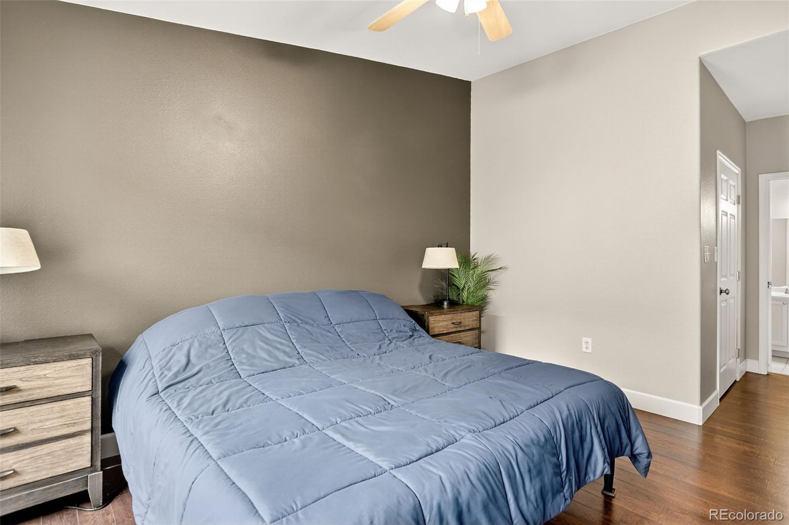 8415 Pebble Creek Way, Unit 203 Highlands Ranch, CO 80126 - Photo 17 of 36 a bedroom with a bed and flowerpot