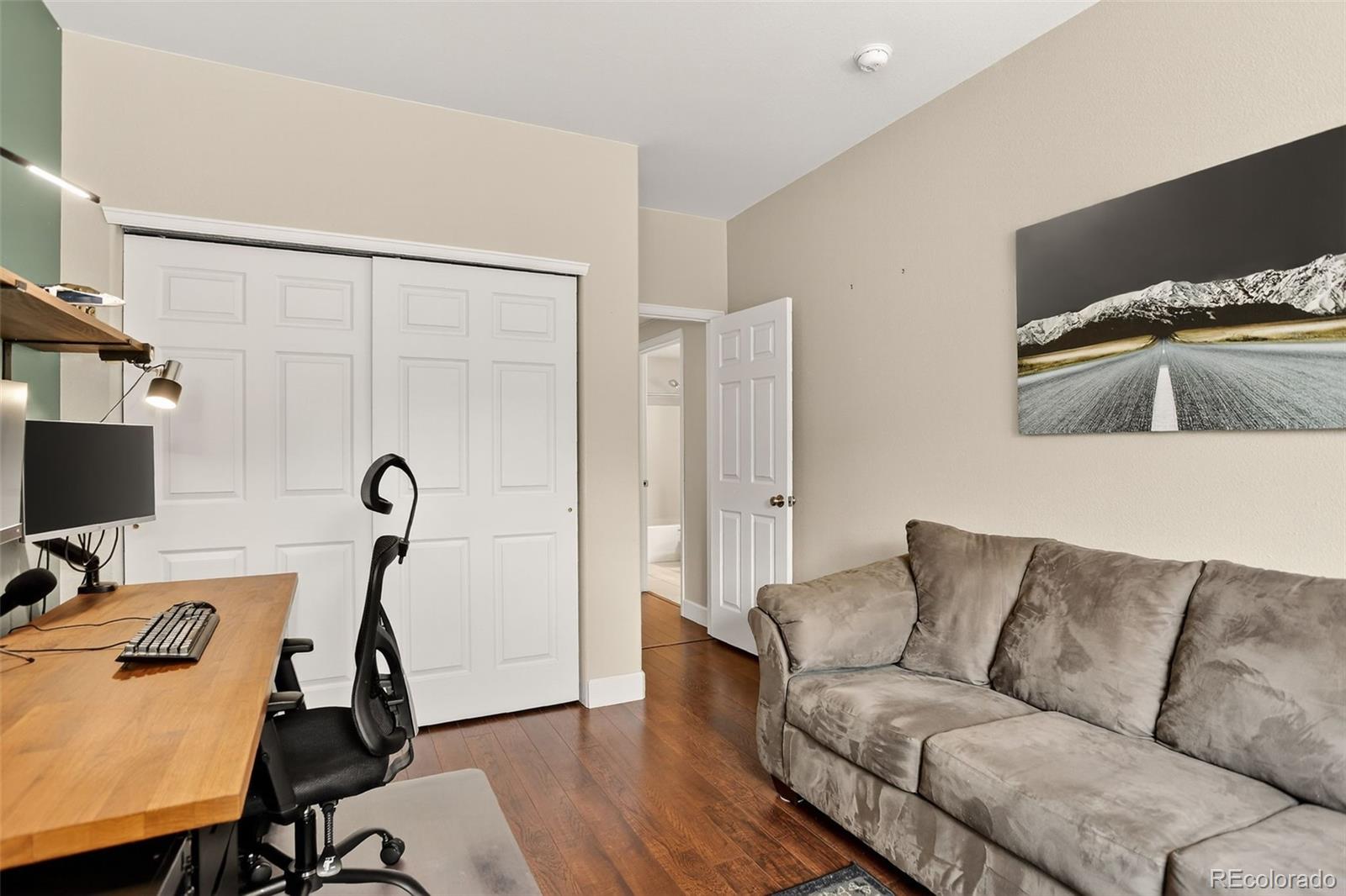 8415 Pebble Creek Way, Unit 203 Highlands Ranch, CO 80126 - Photo 19 of 36 a living room with furniture and a flat screen tv