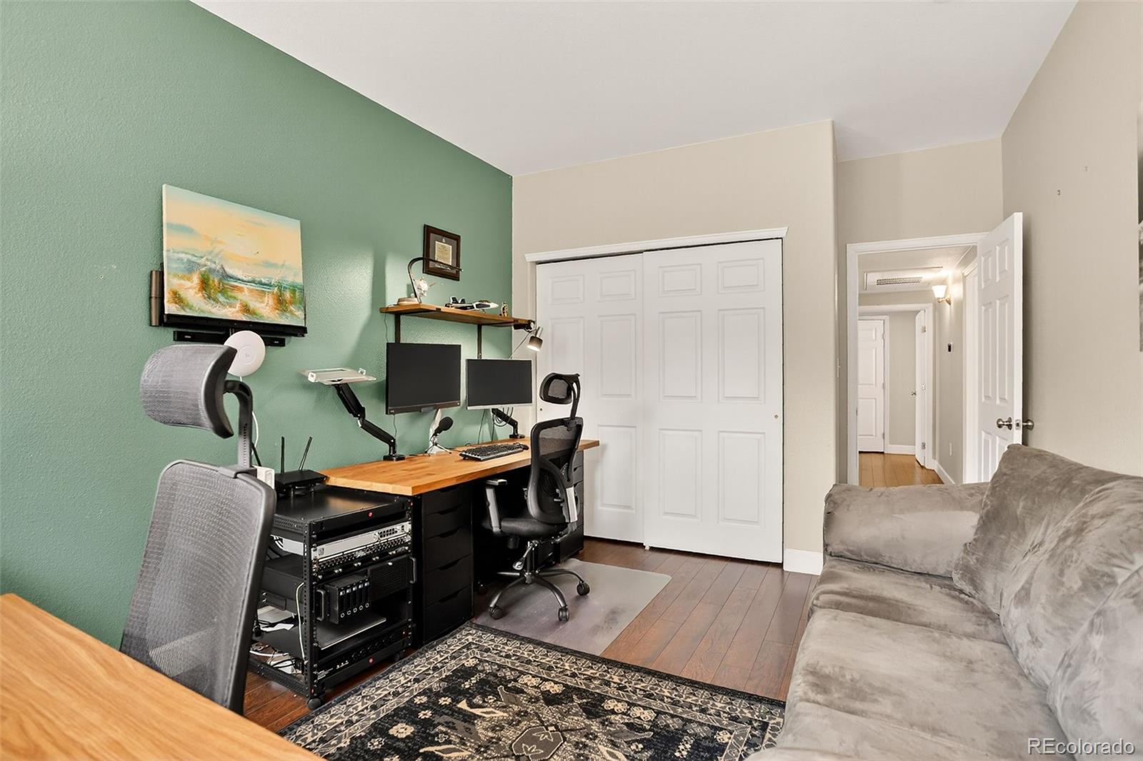 8415 Pebble Creek Way, Unit 203 Highlands Ranch, CO 80126 - Photo 21 of 36 a workspace with furniture and a flat screen tv